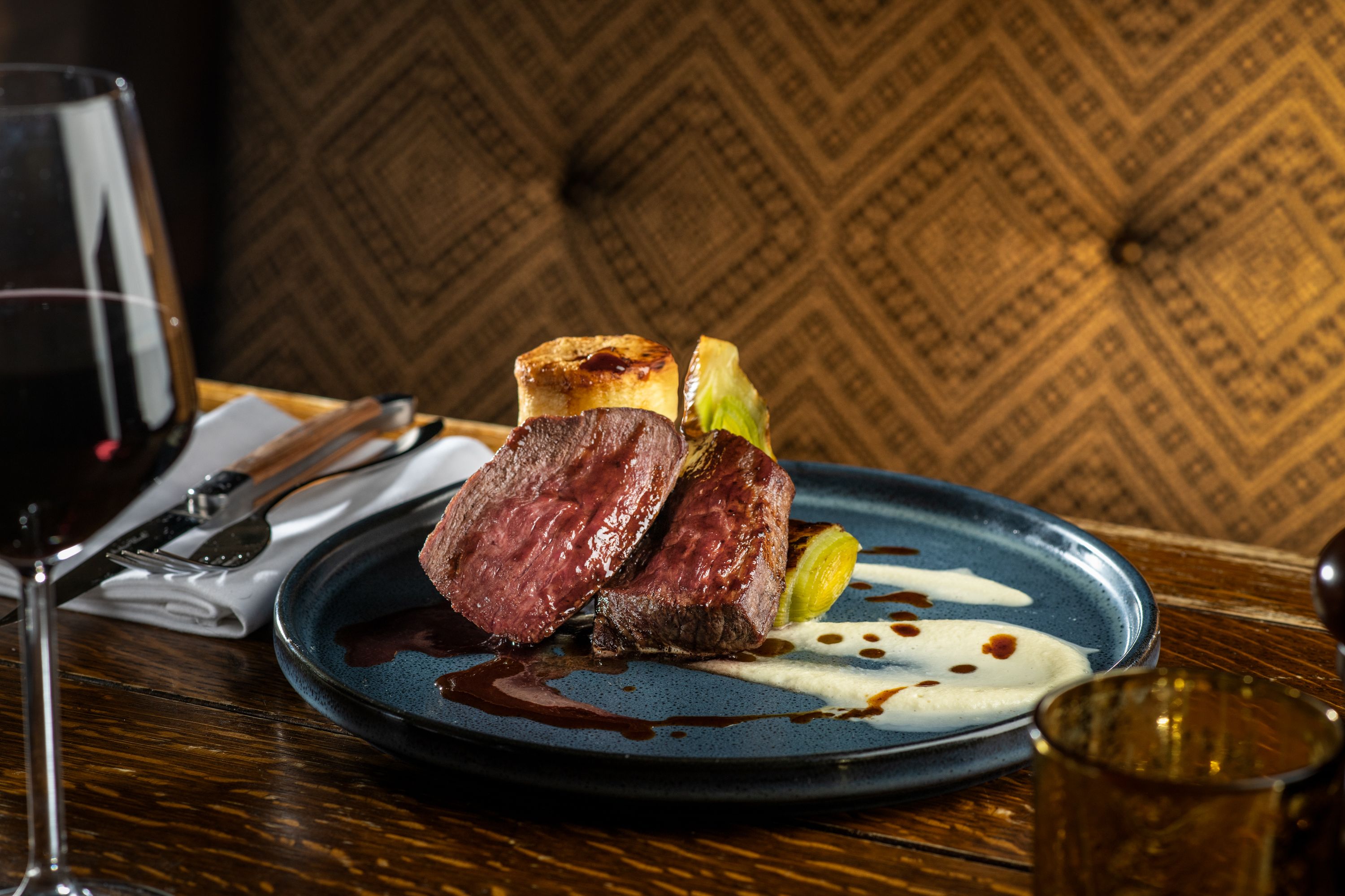 a venison dish with vegetables and wine