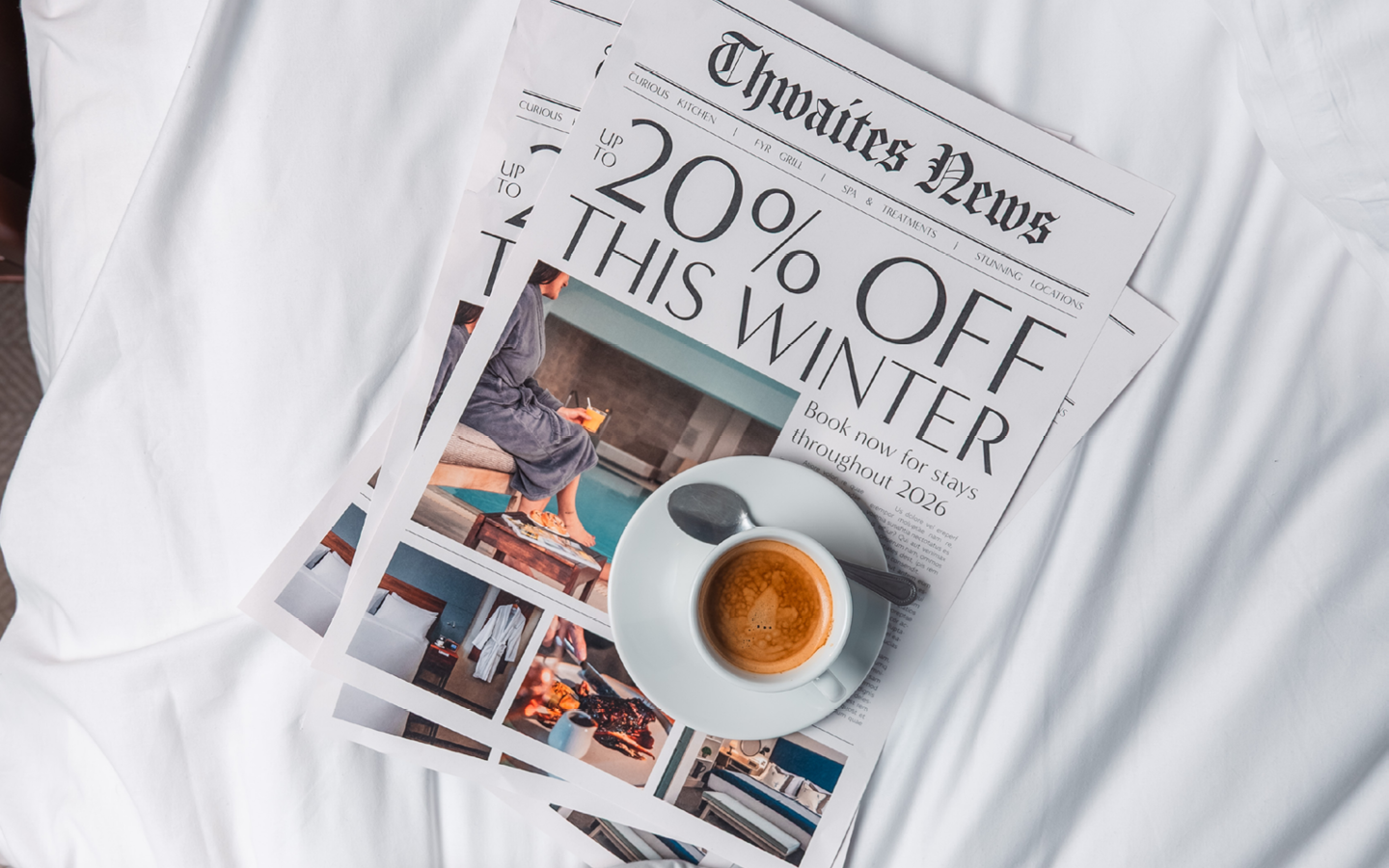 "up to 20% off this winter" newspaper with cup of coffee on bed